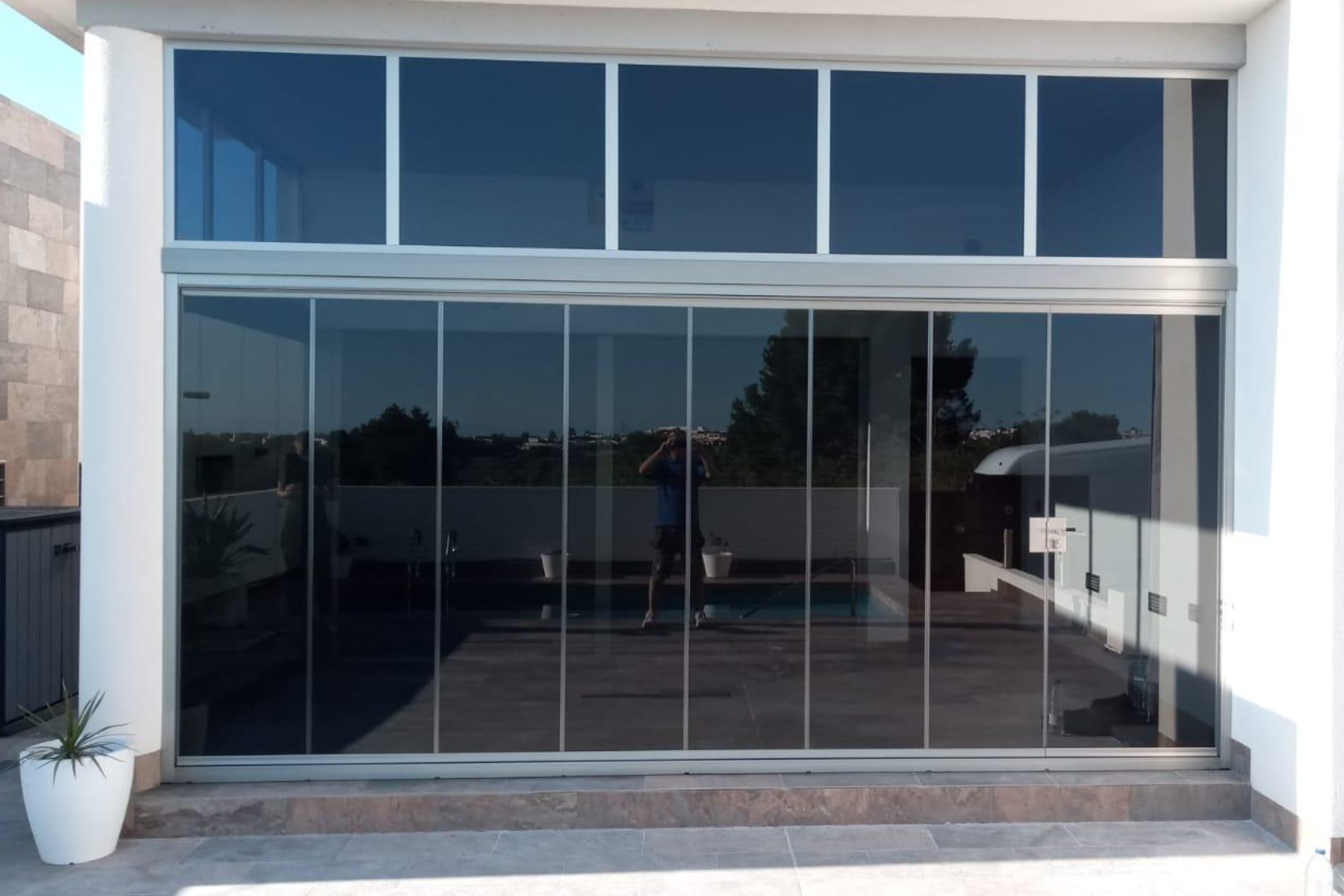 Floor to ceiling tinted glass curtains.