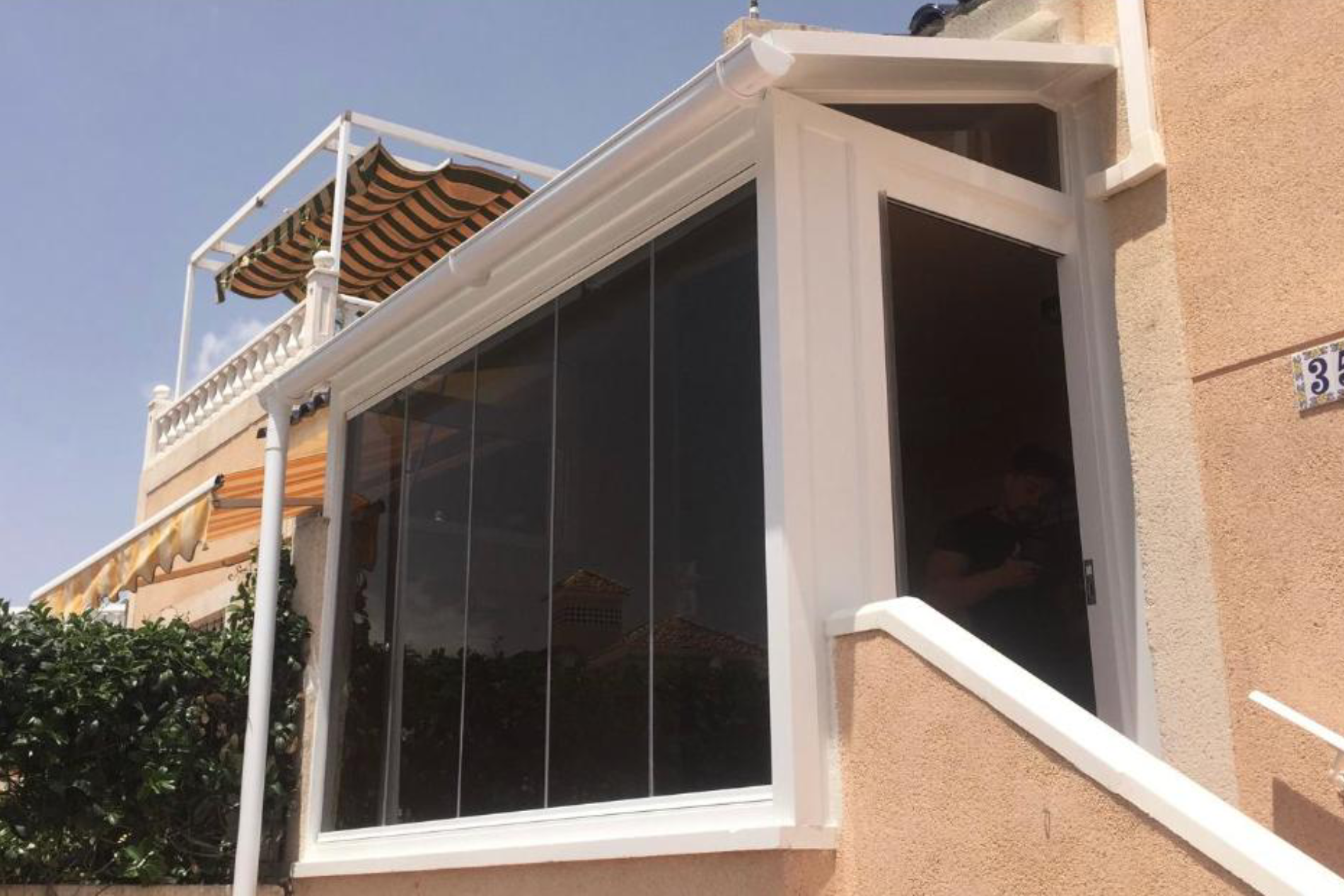 Large tinted windows across front porch.